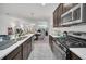 Open kitchen view flowing to the dining area; it showcases stainless steel appliances and ample counter space at 15687 Kinnow Mandarin Ln, Winter Garden, FL 34787