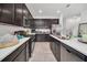 Spacious kitchen with stainless steel appliances, dark cabinetry, and ample counter space for cooking at 15687 Kinnow Mandarin Ln, Winter Garden, FL 34787