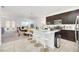 Modern kitchen with island seating, stainless steel appliances, and open layout to the dining area at 15687 Kinnow Mandarin Ln, Winter Garden, FL 34787