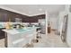 Bright kitchen featuring a large island with seating, stainless steel appliances, and access to the entryway at 15687 Kinnow Mandarin Ln, Winter Garden, FL 34787