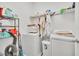 Laundry room featuring side by side washer and dryer, as well as storage shelving for all your laundry needs at 15687 Kinnow Mandarin Ln, Winter Garden, FL 34787