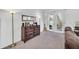 Living room showcasing a dresser with a mirror, decorative lamps and easy access to the outside patio at 15687 Kinnow Mandarin Ln, Winter Garden, FL 34787