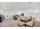 Inviting living room featuring a dining area, neutral tones, and plenty of natural light at 15687 Kinnow Mandarin Ln, Winter Garden, FL 34787