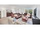 Inviting living room featuring neutral tones, comfortable seating, and natural light from the sliding glass door and window at 15687 Kinnow Mandarin Ln, Winter Garden, FL 34787