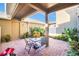 Charming brick patio featuring outdoor seating surrounded by lush landscaping, ideal for relaxation at 15687 Kinnow Mandarin Ln, Winter Garden, FL 34787
