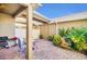 Inviting brick patio with grill and seating, surrounded by lush greenery, perfect for outdoor gatherings at 15687 Kinnow Mandarin Ln, Winter Garden, FL 34787