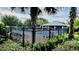 Community swimming pool surrounded by lush landscaping and palm trees, perfect for relaxation at 15687 Kinnow Mandarin Ln, Winter Garden, FL 34787