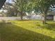 Spacious backyard with lush lawn and mature trees providing shade at 20 S Flag Ct, Kissimmee, FL 34759