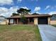 Charming single-story home with a well-maintained lawn and attached garage at 20 S Flag Ct, Kissimmee, FL 34759