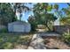 Private backyard with a detached garage and a paved seating area at 204 E Harvard St, Orlando, FL 32804