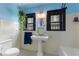 Charming bathroom featuring a pedestal sink, classic tile, and black framed windows at 204 E Harvard St, Orlando, FL 32804