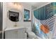 Charming bathroom features a modern vanity, round mirror, and decorative shower curtain at 204 E Harvard St, Orlando, FL 32804