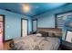 Cozy bedroom features blue walls, hardwood floors, and soft, natural lighting at 204 E Harvard St, Orlando, FL 32804