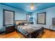Cozy bedroom with hardwood floors, natural light from multiple windows, and modern ceiling fan at 204 E Harvard St, Orlando, FL 32804