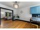 Open dining area with wood floors, a modern light fixture, and seamless flow to living area at 204 E Harvard St, Orlando, FL 32804