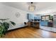 Open concept kitchen and dining area featuring hardwood floors, a modern chandelier, and blue cabinets at 204 E Harvard St, Orlando, FL 32804