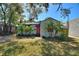 Charming home featuring a red front door, lush landscaping, and mature trees at 204 E Harvard St, Orlando, FL 32804