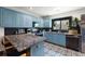 Updated kitchen with blue cabinets, stainless steel appliances, and granite countertops at 204 E Harvard St, Orlando, FL 32804