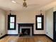 Cozy living room highlights a fireplace, hardwood floors, and natural light from the windows at 204 E Harvard St, Orlando, FL 32804