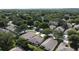 Aerial view of a community with well-spaced homes, lush greenery, and mature trees at 2160 Addison Ave, Clermont, FL 34711