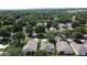 Aerial view of homes in a lush, green community with mature trees and well-maintained lawns at 2160 Addison Ave, Clermont, FL 34711