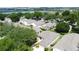 An aerial scene showcasing houses with manicured lawns and mature trees, near a peaceful lake at 2160 Addison Ave, Clermont, FL 34711
