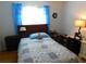 Cozy bedroom features a comfortable bed with stylish blue bedding and a quaint window at 2160 Addison Ave, Clermont, FL 34711