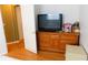 Bedroom features a wooden dresser with drawers, topped with a television and assorted items at 2160 Addison Ave, Clermont, FL 34711