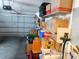 Spacious garage with storage shelves filled with boxes and other items; the garage door is in view at 2160 Addison Ave, Clermont, FL 34711