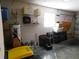 Garage is filled with boxes, paint, and a water heater, with a small window at 2160 Addison Ave, Clermont, FL 34711