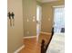 Hallway view into main bedroom with hard surface flooring and a view to the outdoor space at 2160 Addison Ave, Clermont, FL 34711