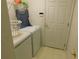 Laundry room featuring a front-loading washing machine and dryer, plus a door at 2160 Addison Ave, Clermont, FL 34711