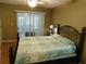 Comfortable bedroom features a decorative bed frame, a ceiling fan, and a window for natural light at 2160 Addison Ave, Clermont, FL 34711
