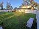 Expansive backyard with mature trees, fencing, patio seating and play equipment at 2211 New Jersey Rd, Lakeland, FL 33803