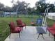 Spacious backyard with patio furniture, mature trees, and fenced perimeter perfect for outdoor activities at 2211 New Jersey Rd, Lakeland, FL 33803