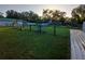 Lush backyard featuring mature trees, a chicken coop, and fenced perimeter at 2211 New Jersey Rd, Lakeland, FL 33803