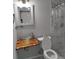Bathroom featuring glass vessel sink on a unique wooden countertop and a shower with marble-patterned tile at 2211 New Jersey Rd, Lakeland, FL 33803