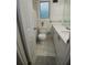 Bright bathroom featuring a white toilet, vanity, and window with a decorative privacy screen at 2211 New Jersey Rd, Lakeland, FL 33803