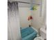 Compact bathroom featuring a blue bathtub with shower and a white toilet at 2211 New Jersey Rd, Lakeland, FL 33803