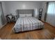 A bedroom featuring hardwood floors, a gray headboard, and a desk with chair at 2211 New Jersey Rd, Lakeland, FL 33803