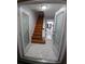 Welcoming entryway features marble flooring, a wooden staircase, and decorative glass doors at 2211 New Jersey Rd, Lakeland, FL 33803