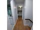 A hallway featuring hardwood floors and a view into a bedroom at 2211 New Jersey Rd, Lakeland, FL 33803