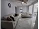 Bright living room with marble floors, neutral sofas, and a view into the laundry area at 2211 New Jersey Rd, Lakeland, FL 33803