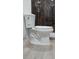 Modern toilet with elongated bowl and wood-look tile flooring in bathroom with shower at 2211 New Jersey Rd, Lakeland, FL 33803