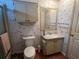 Compact bathroom with floral wallpaper, vanity, and toilet at 222 Palmer Park Ln, Davenport, FL 33897