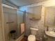 Bathroom featuring a walk-in shower, single sink vanity, toilet, and storage cabinet at 222 Palmer Park Ln, Davenport, FL 33897