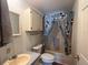 Full bathroom with patterned wallpaper, tub-shower, and vanity at 222 Palmer Park Ln, Davenport, FL 33897