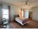 Cozy bedroom with ceiling fan, bright windows, and adjacent bathroom at 222 Palmer Park Ln, Davenport, FL 33897