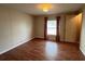 Bedroom featuring wood-look floors, a window with curtains, and a closet at 222 Palmer Park Ln, Davenport, FL 33897