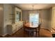 Traditional dining room with wood table, chandelier, built-in hutch, and light-filled window at 222 Palmer Park Ln, Davenport, FL 33897
